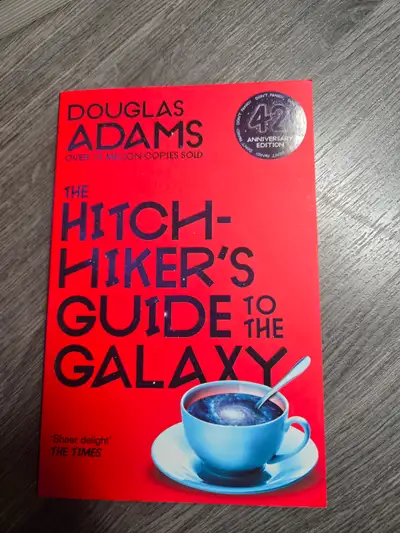 This is a copy of The Hitchhiker's Guide to the Galaxy by Douglas Adams, specifically the 42nd Anniv...