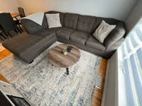 Ashley furniture couch with rug and coffee table