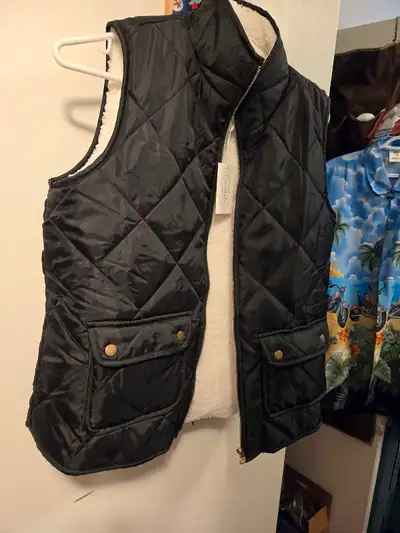 This Mud Pie black quilted vest, size medium, is brand new with tags! It's a stylish and cozy additi...