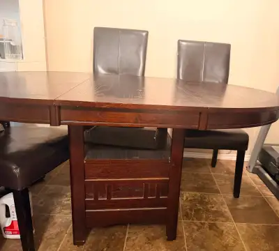 Dining table with four chairs. Stretchable to 6 chair capacity., View more