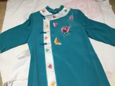 Size 8 woman’s Cheongsam. Unknown material.