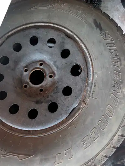 These pre-owned Firestone Winterforce LT tires are mounted on steel rims that came off a jeep Wrangl...