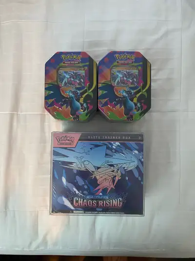 Pokémon Chaos Rising ETB and 2 Mega Charizard Tins, View more