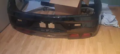 Rear bumper skin in black mint. Tail lights available for 300 bucks