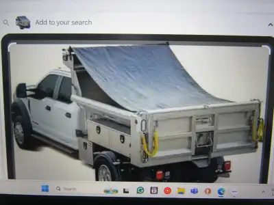 Dump truck mesh tarp. Approximately 7' x 21', new condition, never used.