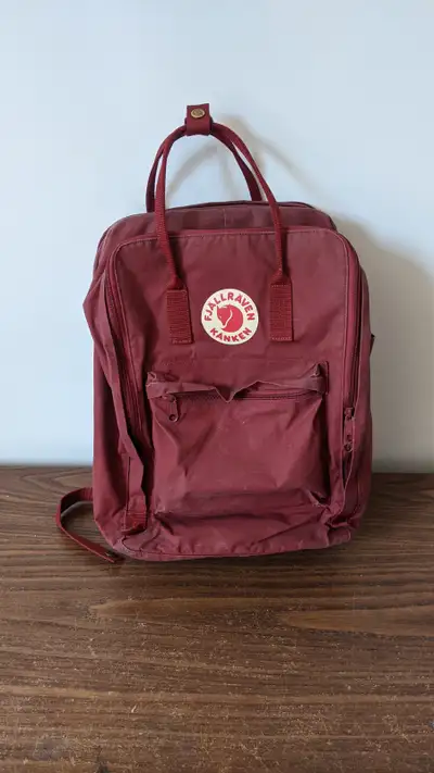 This is a Fjallraven Kanken bag in a burgundy colour that I don't reach for anymore. There is some c...