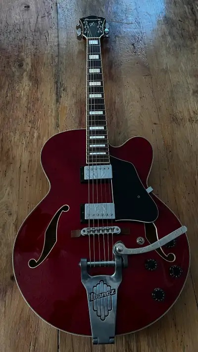 Wine red hollowbody. Plays great, sounds great. 1 minor blemish on the back (see pic). Model Ibanez...
