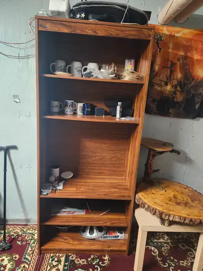 Tall wooden book shelf has 4 shelves you can arrange the way you want. In great condition. Asking 40...