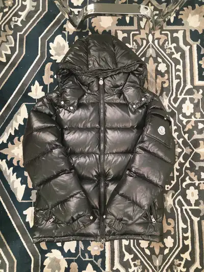 I'm offering a stylish, gently worn Moncler puffer jacket, perfect for staying warm and fashionable....