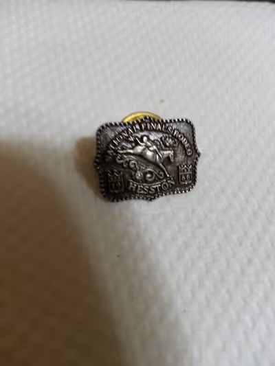 //NATIONAL FINALS RODEO PIN\\ NFR 1986 Hesston pin. Nice used item that has a bareback rider on it a...