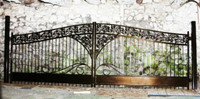 Metal gate for the driveway with cast iron decor