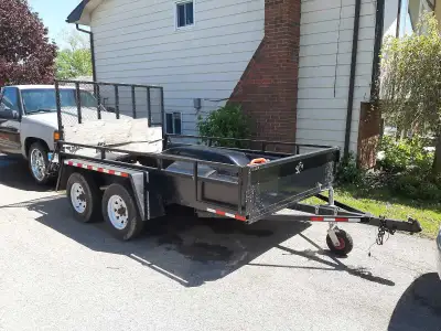 Heavy duty utility trailer. 6'x10' 2" thick wood floor. Dual axel. 5000 lb Champion winch. 4 Almost...