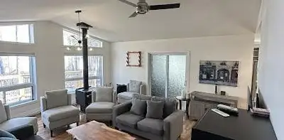 This 2009-built lakefront retreat perfectly blends modern convenience with rustic charm, featuring v...