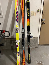 Three sets of skis helmet and goggles 