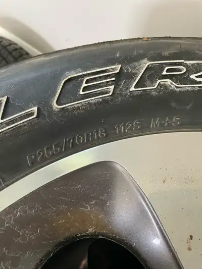 Selling a set of four Jeep JK factory wheels with Bridgestone Dueler A/T tires, size P255/70R18 112S...