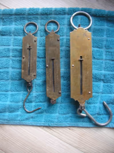 IN ESTEVAN SASK., THREE VINTAGE WEIGHT SCALES, LARGE ONE IS 50 LBS., CENTER ONE IS 15 LBS., SMALL ON...