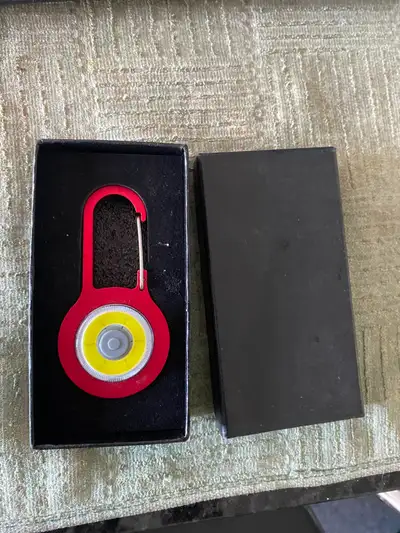 Compact LED keychain flashlight with a built-in carabiner, View more