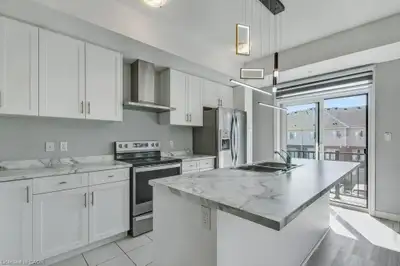 The townhouse has 1,200 square feet of living space. The main level features a great room, a kitchen...