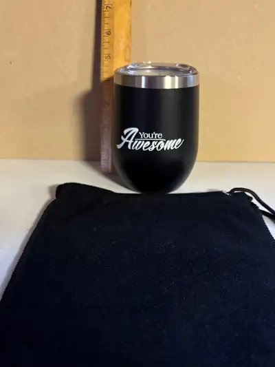 New, s/s beverage cup with lid and carrying tote for sale. Front porch pick up from a clean pet/smok...