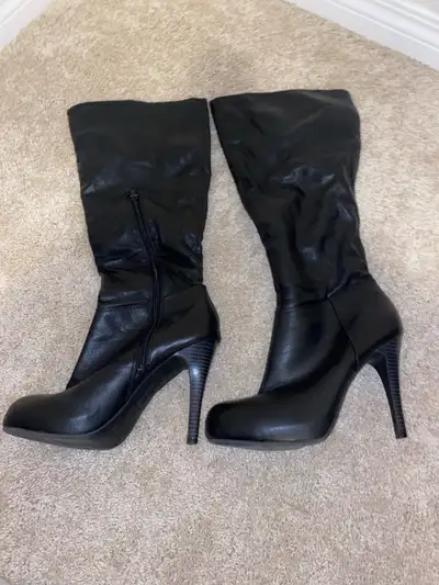 Pair of black high heel boots, they go almost up to the knee. 4.5” heel. Size 10. Rubber sole, fake...
