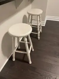 Two slightly different white bar stools 