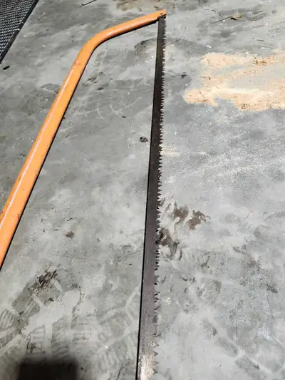 This is a used bow saw in fair condition, perfect for cutting small trees and branches.