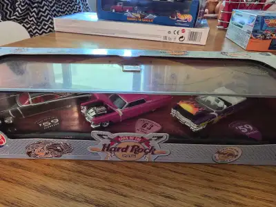 This collectible Hot Wheels Cars of the Hard Rock Cafe set features three iconic Cadillac models, in...