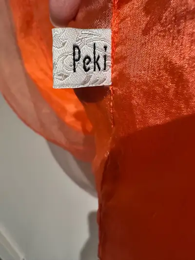 Add a pop of colour to your look with this vibrant orange Peki scarf! This pre-owned scarf is in goo...