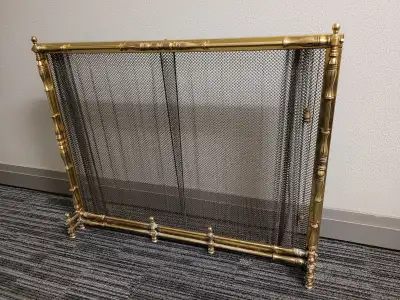 Antique solid brass fireplace screen with retractable mesh panels in very good condition. The screen...