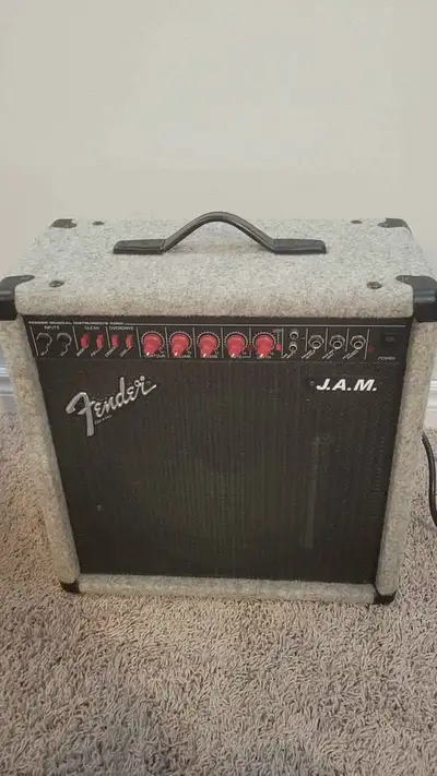 Vintage Fender J.A.M. combo amp has grey carpeted exterior with black grille cloth. This solid state...