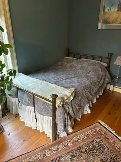 This is a charming antique brass bed, perfect for adding a touch of vintage elegance to any bedroom....