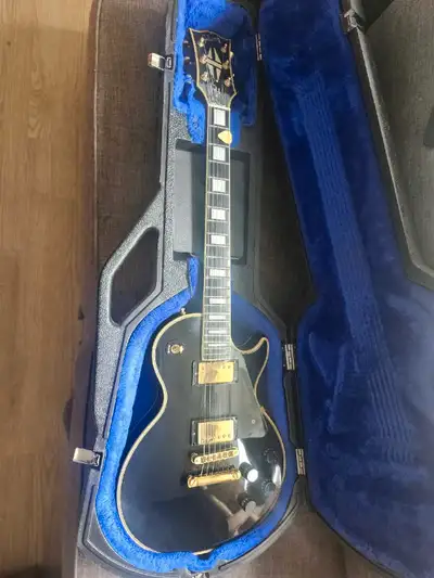 For serious players & collectors—this iconic Gibson Les Paul Custom in stunning Ebony with gold hard...
