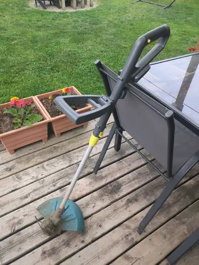 Yardworks String Trimmer with battery and charger. Works great. Stored inside. Extra line reel inclu...