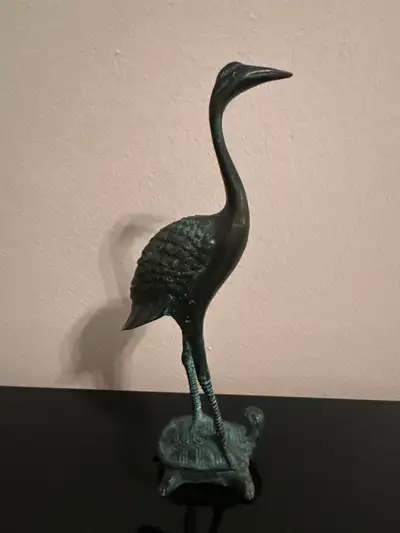Vintage bronze crane standing on a turtle sculpture., View more