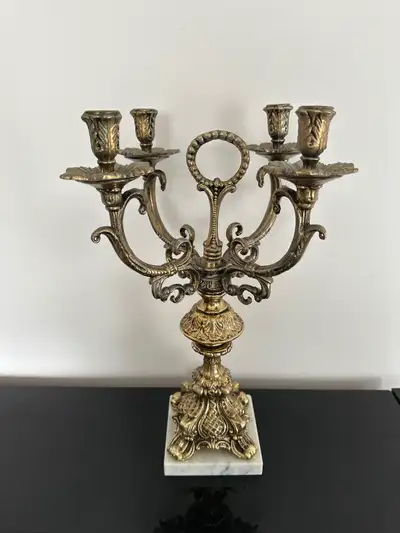 Vintage gold solid metal four-arm candelabra.