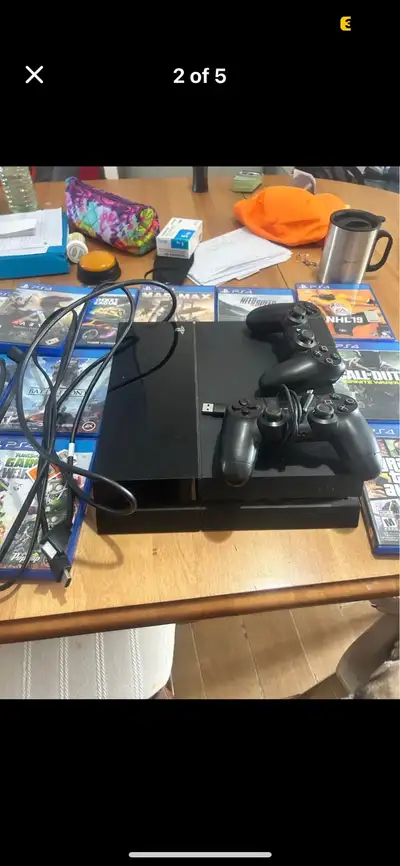 PS4 Slim with 16 games 2 controllers, View more