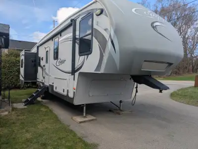 lovingly cared for and well maintained 35ft, Cougar High Country 5th wheel. 50AMP. New 25000btu air...