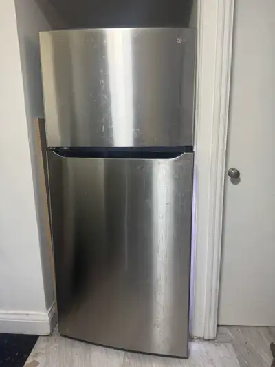This LG top freezer refrigerator, model LTCS20020S, offers 20 cubic feet of storage space and is in...