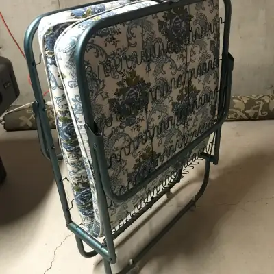 single bed, folding, roll-away, metal frame with mattress. Unfolding flat, the bed is 76 inch long,...