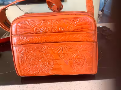 This beautiful leather purse has an adjustable strap. 6 compartments clean and slightly used. Must b...