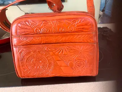 This beautiful leather purse has an adjustable strap. 6 compartments clean and slightly used. Must b...