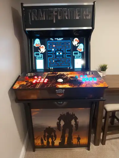 Transformers themed full size arcade; -32" screen, has 4" speakers and amp -Backlit Marquee -trackba...