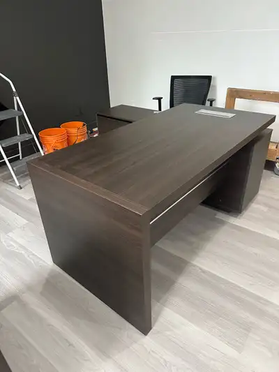 This is an office desk, it is in good condition. It has a dark brown wood finish and a built in powe...