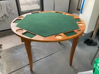 Poker table with folding legs for easy storage. Height 30 Diameter 47 1/4. Case of poker chips.