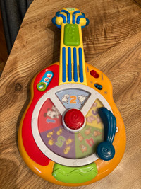 Musical child’s guitar- plays both English & French