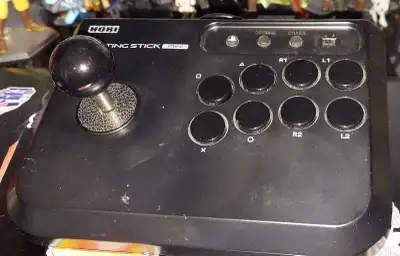 Hori fightstick for PS3, PS4 and PC. Has a very tiny chip in the corner. Works perfectly fine.