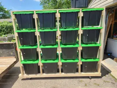 Tote Storage Rack on wheels. Will fit under garage door. Top has plywood for bulky storage. Very stu...