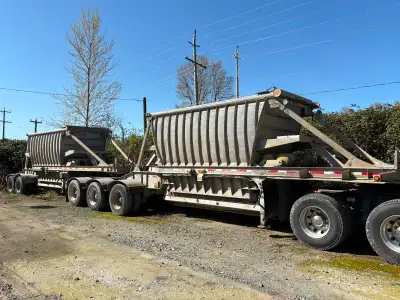 Set of Super B Bottom Dump Mining trailers 600 cubic feet capacity each Air operated gates Plastic l...
