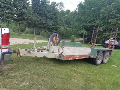 Heavy duty 16 ft flat deck trailer with beaver tail loading ramps. Tandem 8,000 pound axles with 235...
