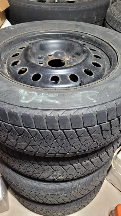 Bridgestone's stick-to-ice Blizzaks! 225x65x17R's. DOT is 2815. These have been stored indoors for y...